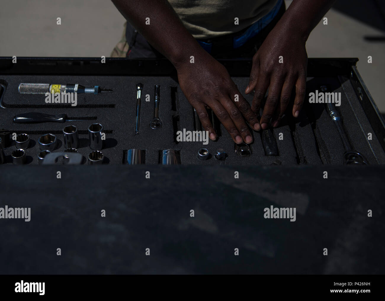 Senior Airman Clarence Williams, 455th Expeditionary Aircraft Maintenance Squadron weapons maintainer, prepares tools to load two GBU (Guided Bomb Unit)-54 on an F-16C Fighting Falcon during routine weapons upload at Bagram Airfield, Afghanistan, June 07, 2016. Airmen with the 455th EAMXS weapons flight ensure the aircraft are armed, combat ready, and fully operational before every F-16 take off. (U.S. Air Force photo by Senior Airman Justyn M. Freeman) Stock Photo