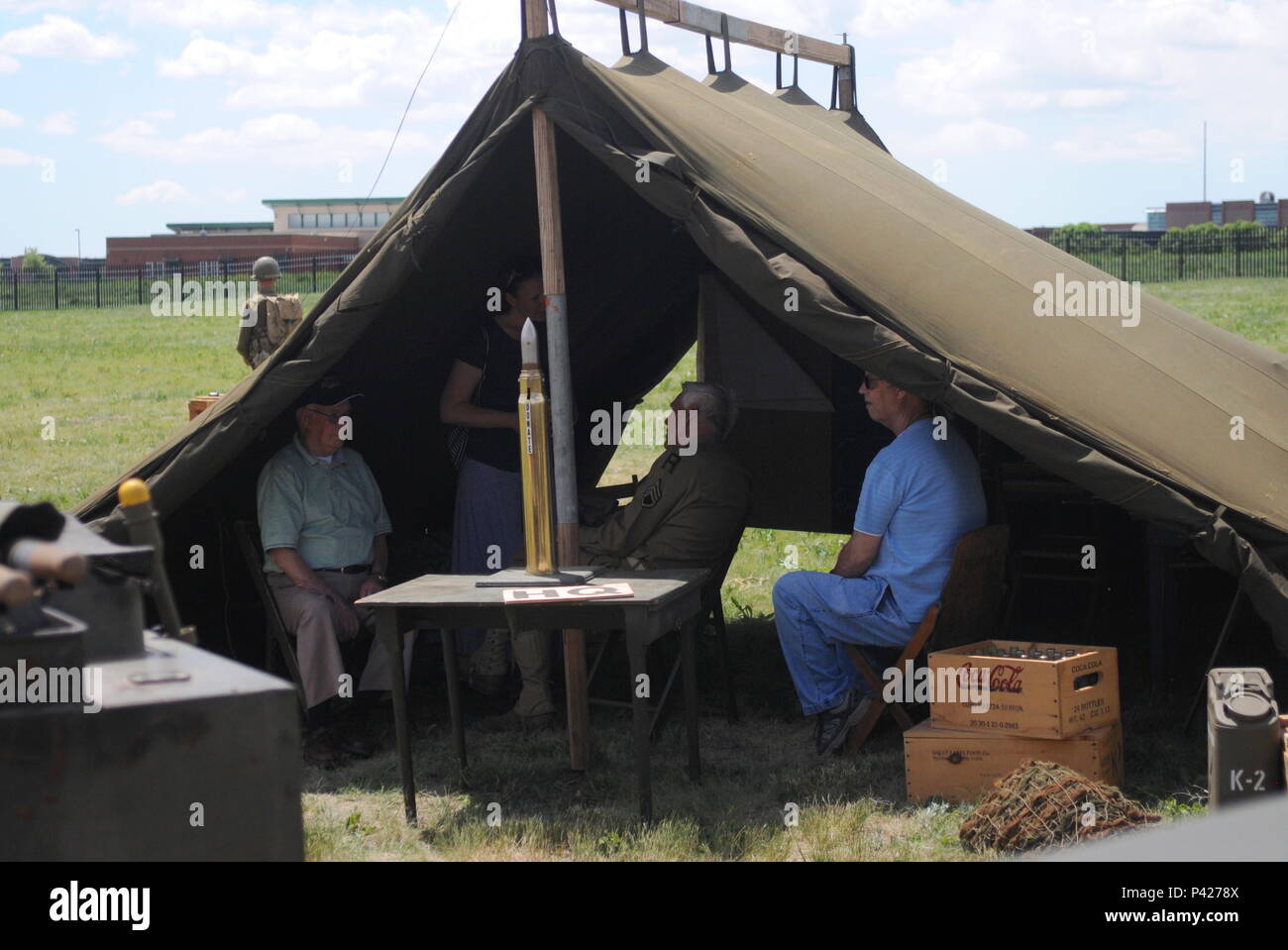 FORT CARSON, Colorado – Bob Burrow (left), a World War II veteran who served with 2nd Battalion, 317th Infantry Regiment, 80th Infantry Division, attended the 4th Infantry Division Museum reopening and Living History Day event, held outside Fort Carson’s Gate 1, June 4, 2016.  Burrows, shaded in a military tent display, shared his recollection of the 4th Infantry Division with the Soldiers and community members also in attendance of the event.  (U.S. Army photo by Capt. Shaun T. Manley, 3rd ABCT Public Affairs, 4th Inf. Div.) Stock Photo