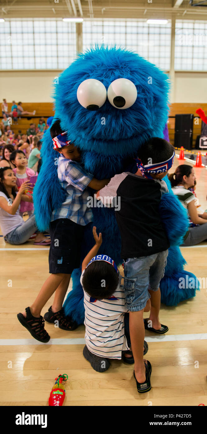 Sesame Street character Cookie Monster gives a big hug to a military  dependents during the Sesame Street USO Experience for Military Families  show at Travis Air Force Base, Calif. The Sesame Street