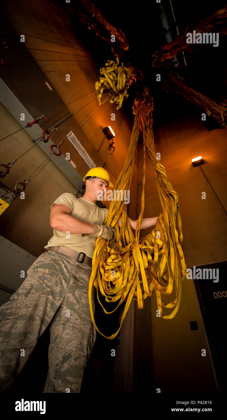 Senior Airman Scott Plummer, 2nd Operations Support Squadron aircrew flight equipment journeyman, hangs a wet canopy in a drying tower at Barksdale Air Force Base, La., June 7, 2016. Plummer hung the canopy to dry prior to re-packing it into a chute deployment bag. Wet canopies need to be dried to avoid mildew and other issues caused by water. (U.S. Air Force photo/Senior Airman Mozer O. Da Cunha) Stock Photo