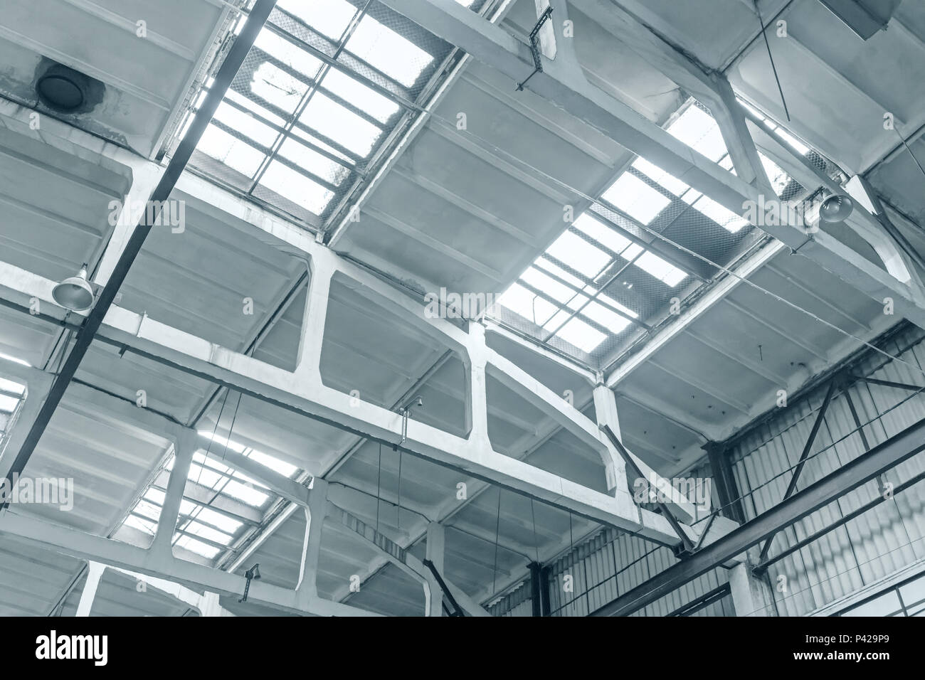 industrial ceiling structure with top lightning. large warehouse or factory interior Stock Photo