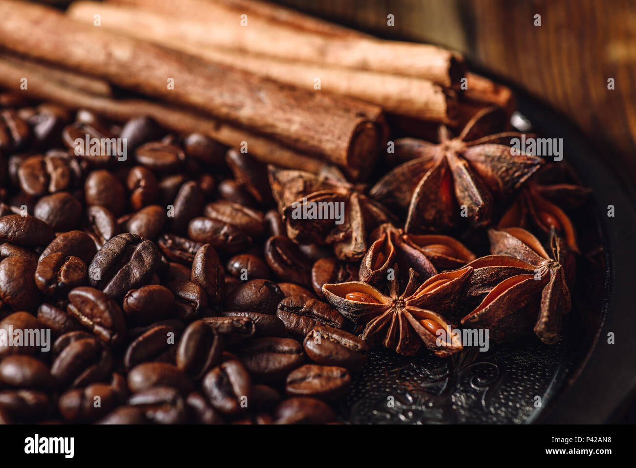 Coffee Beans with Cinnamon Sticks and Chinese Star Anise on Metal Plate