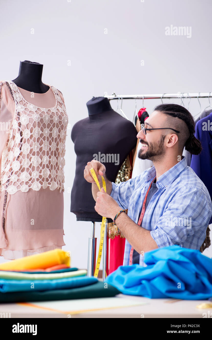 Male tailor working in the workshop on new designs Stock Photo - Alamy