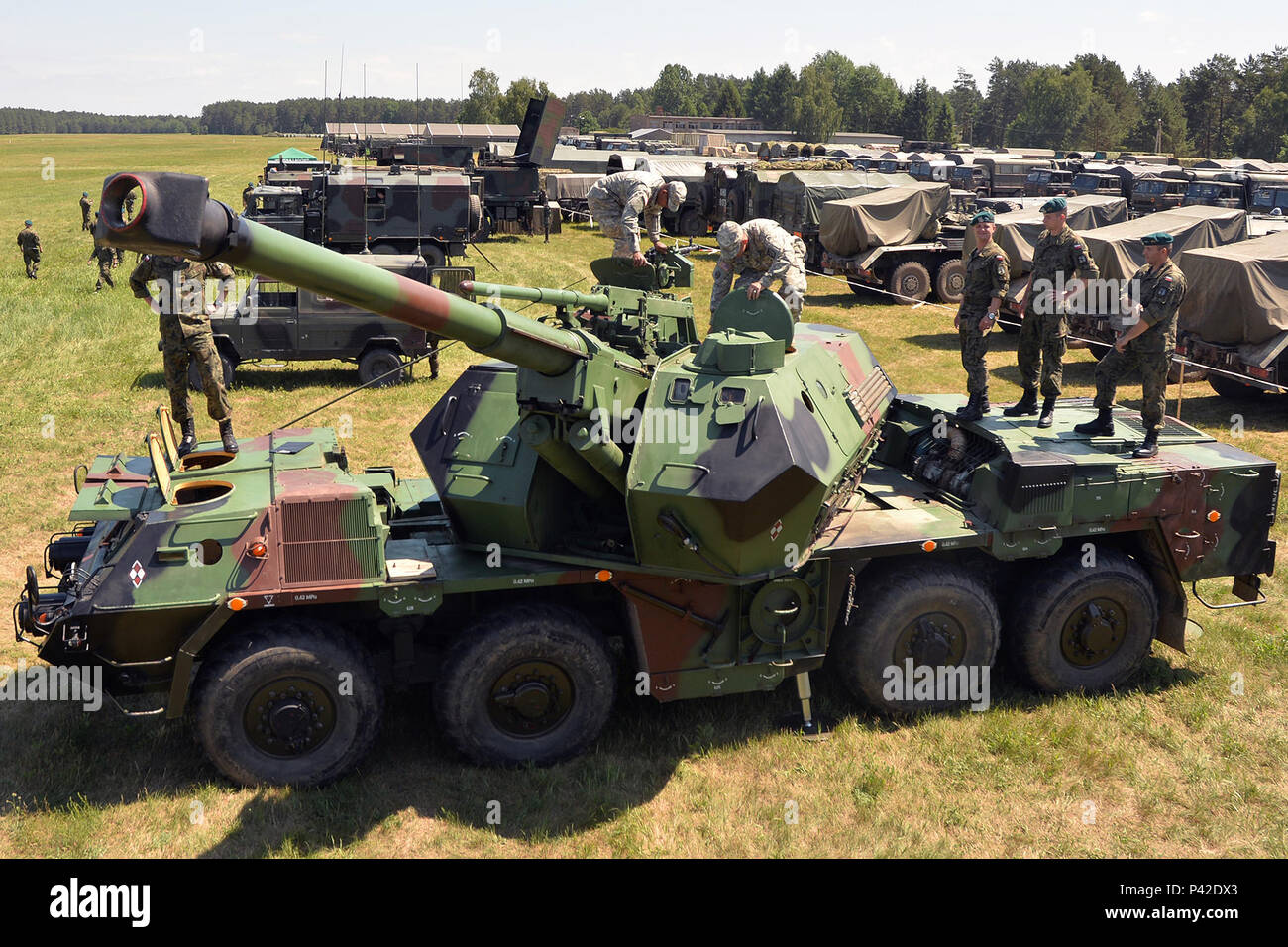 Soldiers of the 5th Battalion, 113th Field Artillery Regiment (High Mobility Artillery Rocket System), North Carolina Army National Guard, examine a 152mm AHS DANA, a self-propelled artillery vehicle, during Exercise Anakonda 16 at Jaworze Training Area, Poland, June 5, 2016. The North Carolina Guardsmen and Polish soldiers learned about each other’s artillery, vehicles and other equipment during this part of the exercise. AN16 is a Polish national exercise that seeks to train, exercise, and integrate Polish national command and force structures into an allied, joint, and multinational environ Stock Photo