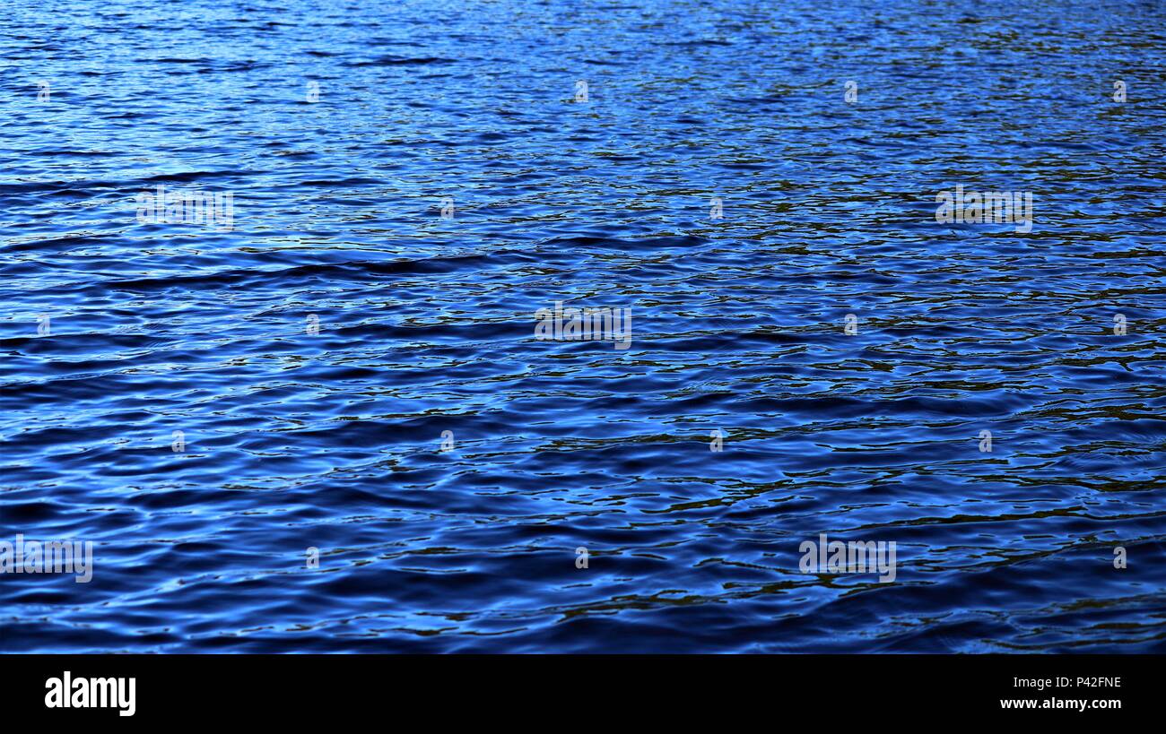 small ripples in the deep blue water Stock Photo