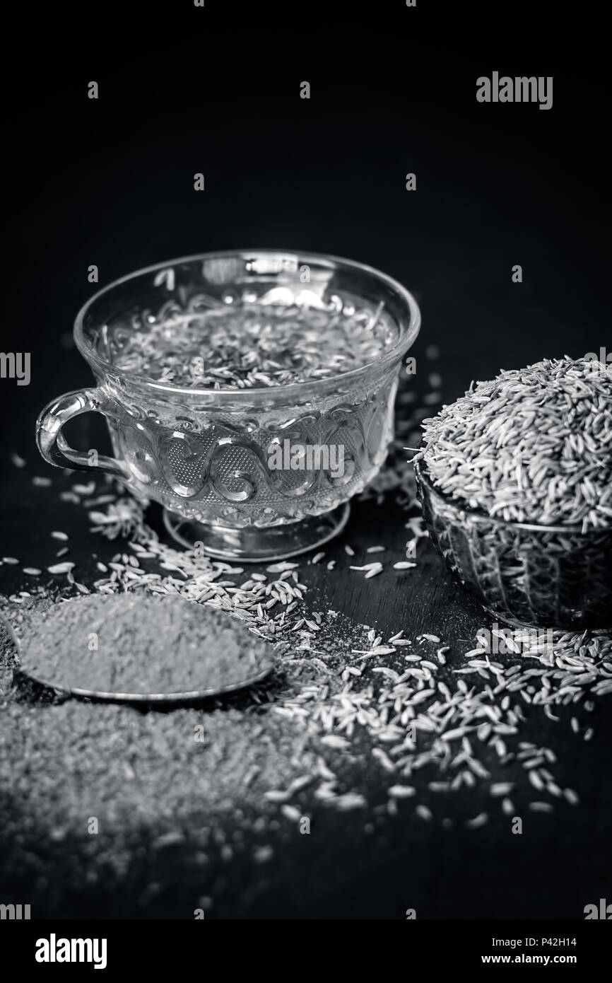 Cumin,Cuminum cyminum with its powder and its tea on brown wooden ...