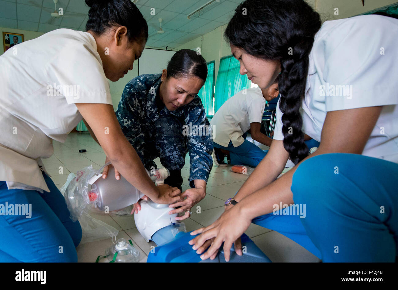 160610-N-QW941-115 DILI, Timor Leste (June 10, 2016) Hospital Corpsman 1st Class Rosella Reyes, a native of the Philippines, conducts basic life support training for Timorese students at the International Health Institute during Pacific Partnership 2016. This year marks the sixth time the mission visited Timor Leste since its first visit in 2006. Medical, engineering and various other personnel embarked aboard hospital ship USNS Mercy (T-AH 19) are working side-by-side with partner nation counterparts, exchanging ideas, building best practices and relationships to ensure preparedness should di Stock Photo