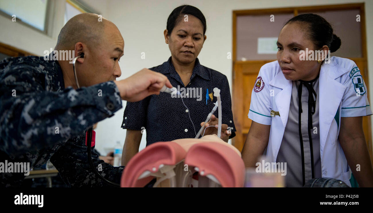 160610-N-QW941-329 DILI, Timor Leste (June 10, 2016) Hospital Corpsman 1st Class Soutsakhone Sanethavong, a native of Portland, Oregon, interacts with Timorese nurses while conducting advanced life support training at the International Health Institute during Pacific Partnership 2016. This year marks the sixth time the mission visited Timor Leste since its first visit in 2006. Medical, engineering and various other personnel embarked aboard hospital ship USNS Mercy (T-AH 19) are working side-by-side with partner nation counterparts, exchanging ideas, building best practices and relationships t Stock Photo