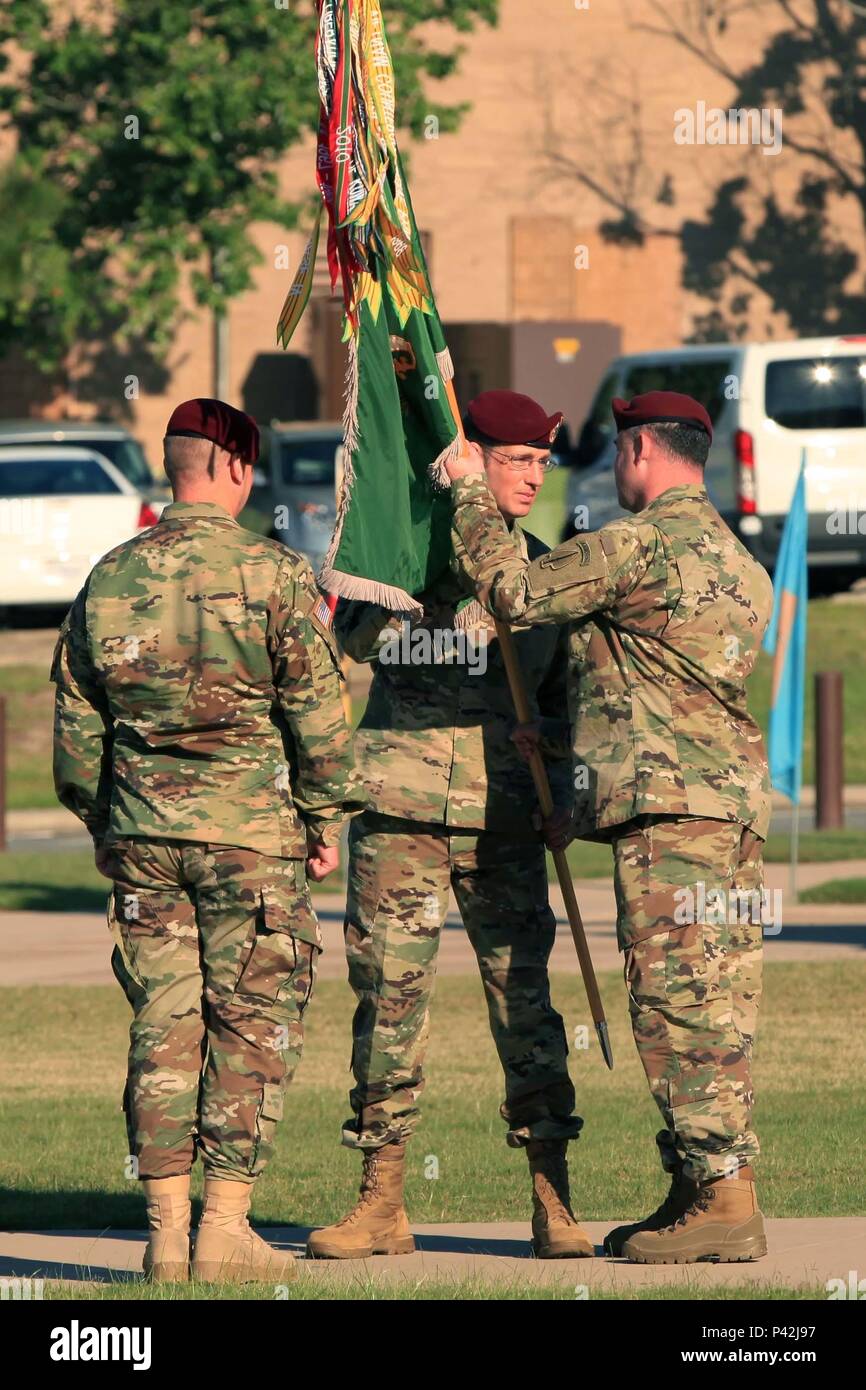 Lt. Col. Bradford Burris, outgoing commander of 8th Military Information Support Battalion, 4th Military Information Support Group, passes the battalion guidon to 4th MISG commander, Col. Robert Curris, during the battalion change of command ceremony on Fort Bragg, June 10. During the ceremony, Burris relinquished command of 8th MISB to Lt. Col. Marcus Welch. After commanding the battalion for two years, Burris will go on to attend the National War College at Fort McNair, Washington, D.C. Stock Photo