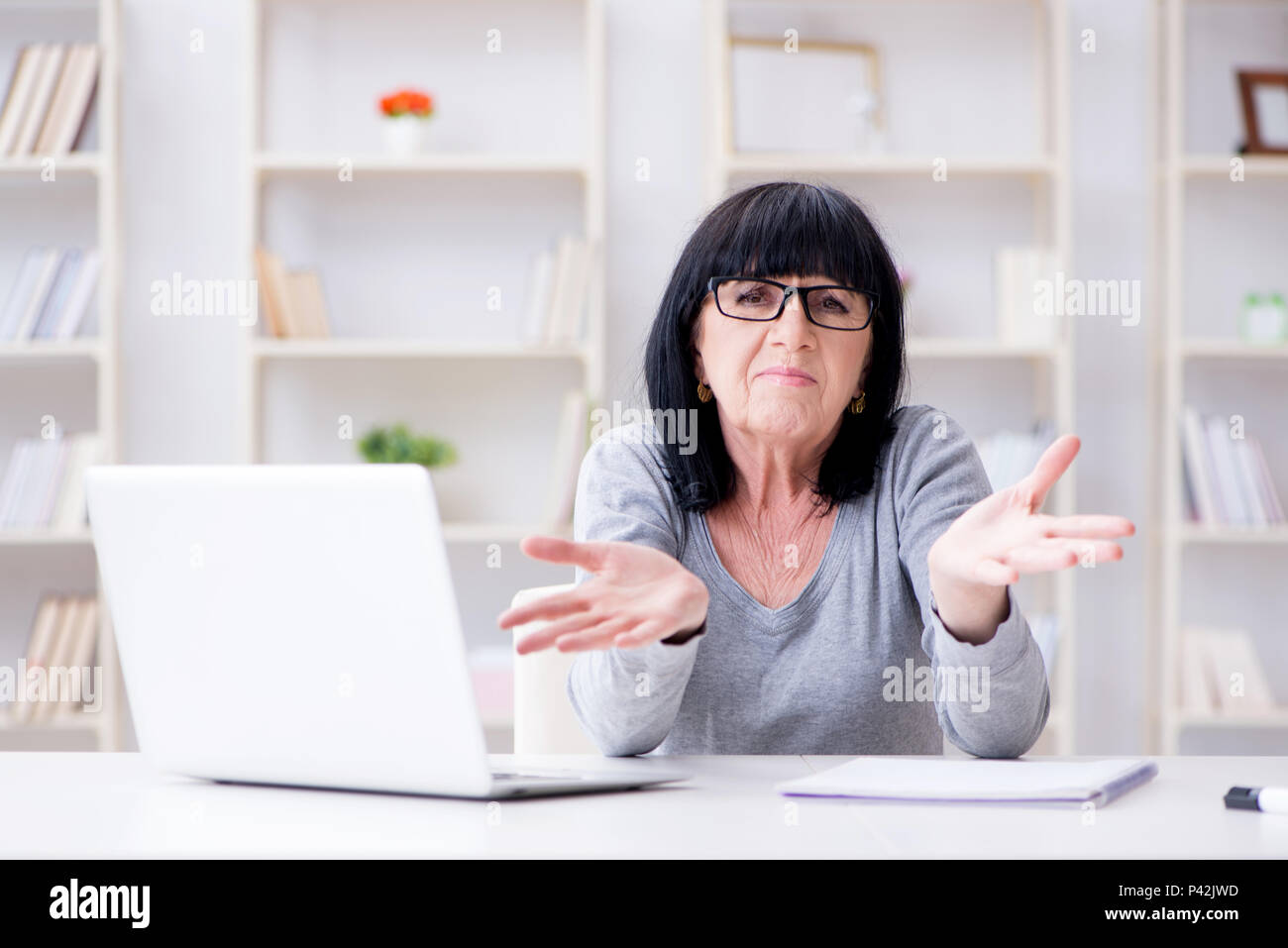 Senior woman struggling at computer Stock Photo