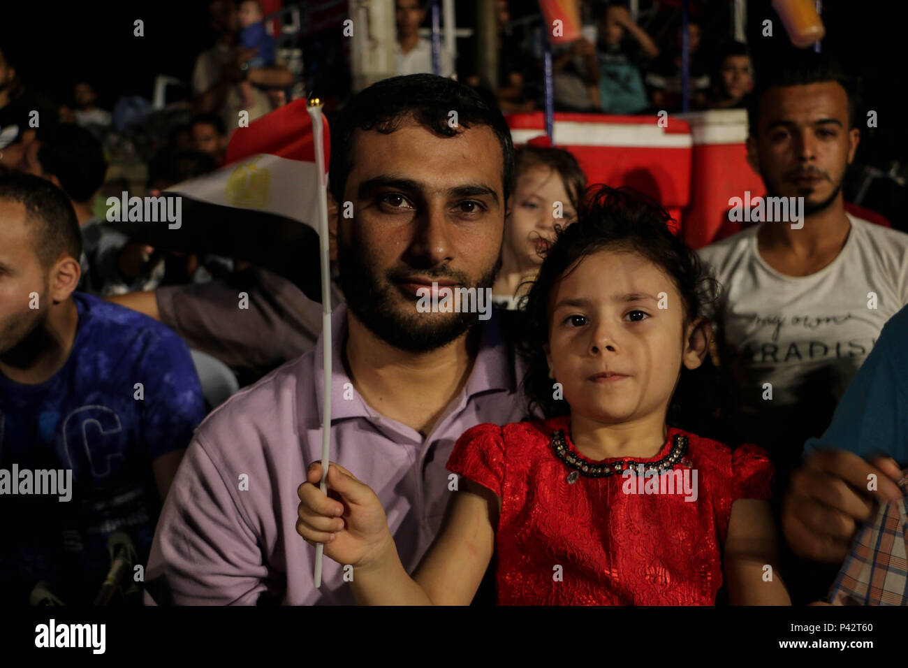 Gaza, Palestine. 19th June, 2018. A Palestinian child carrying the flag of Egypt while watching the match of the Egyptian team in the World Cup in the Gaza port.Palestinians watch on a big screen the Russia 2018 World Cup Group A football match between Russia and Egypt at seaport in Gaza city. Russia won 3-1. Credit: Ahmad Hasaballah/SOPA Images/ZUMA Wire/Alamy Live News Stock Photo