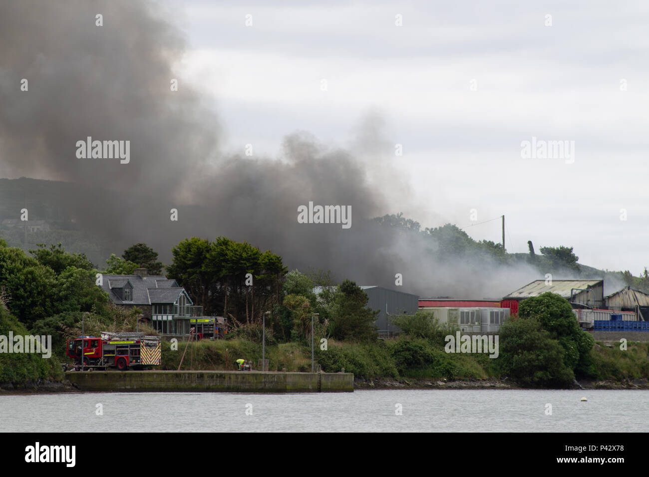 Baltimore, Ireland. 20th June, 2018. A large fire in the fish factory near Baltimore today caused the evacuation of the local school. Huge plumes of toxic smoke were carried towards the school causing the evacuation. Fire appliances from all over the local area attended as firemen battled to control the blaze. Local roads were closed with diversions in place but no casualties were reported. Credit: aphperspective/Alamy Live News Stock Photo