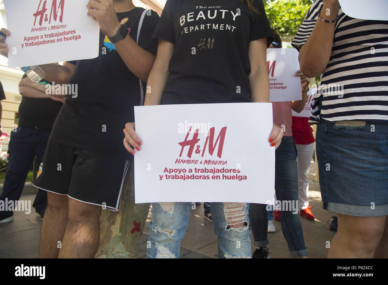 Madrid, Spain. 20th June, 2018. Protesters display placards in support of  the H&M workers.Workers of the H&M logistic center in Madrid has gone on  strike and took to the street of Madrid