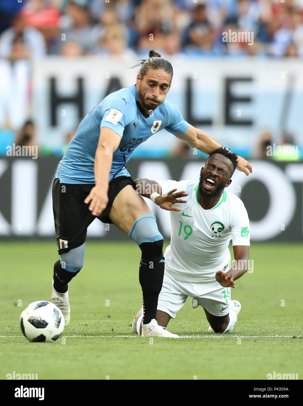 Rostov On Don. 20th June, 2018. Martin Caceres (L) of Uruguay vies with Fahad Almuwallad of Saudi Arabia during a Group A match between Uruguay and Saudi Arabia at the 2018 FIFA World Cup in Rostov-on-Don, Russia, June 20, 2018. Credit: Lu Jinbo/Xinhua/Alamy Live News Stock Photo