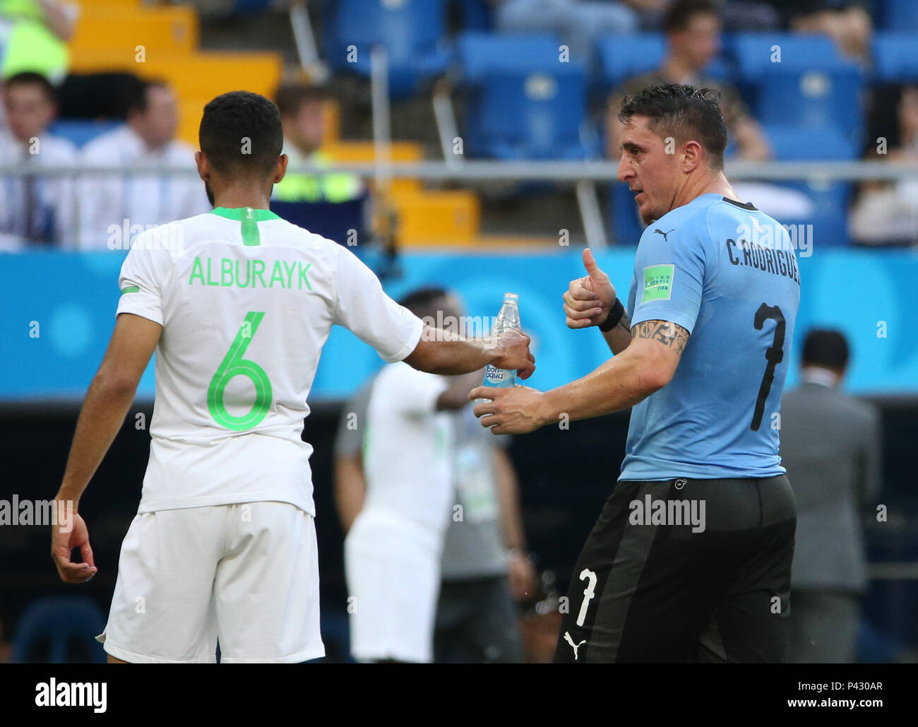 Rostov On Don. 20th June, 2018. Mohammed Alburayk (L) of Saudi Arabia passes a bottle of water to Cristian Rodriguez of Uruguay during a Group A match between Uruguay and Saudi Arabia at the 2018 FIFA World Cup in Rostov-on-Don, Russia, June 20, 2018. Credit: Li Ming/Xinhua/Alamy Live News Stock Photo