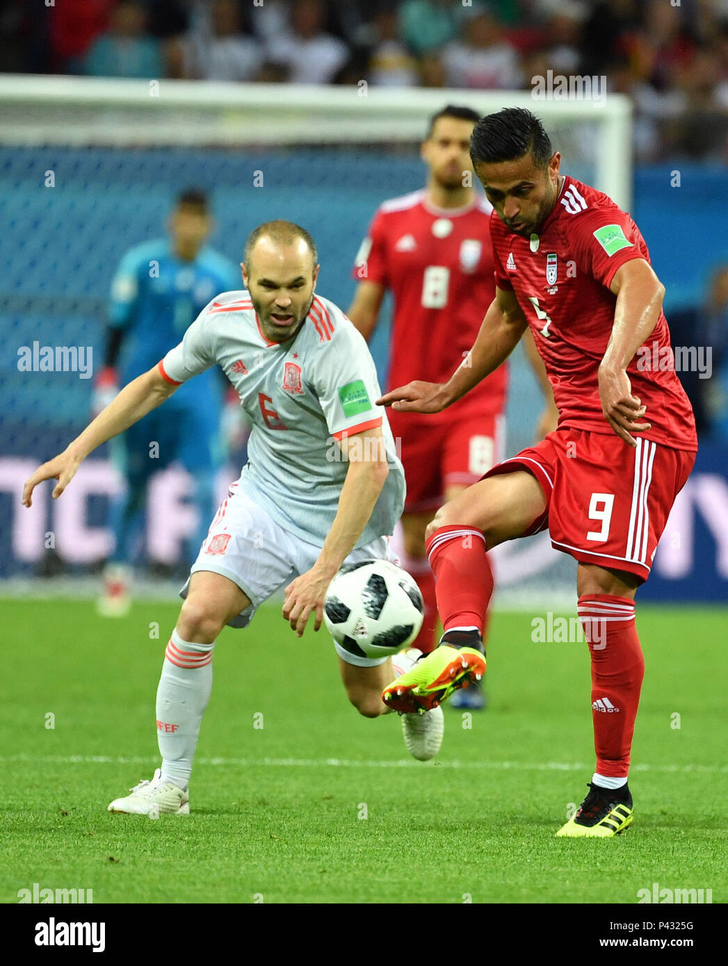 Kazan, Russia. 20th June, 2018. Andres Iniesta (L) of Spain vies with Omid Ebrahimi of Iran during a Group B match between Spain and Iran at the 2018 FIFA World Cup in Kazan, Russia, June 20, 2018. Credit: Liu Dawei/Xinhua/Alamy Live News Stock Photo