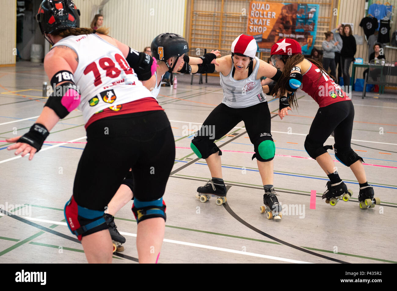 Germany, Potsdam. 14th Apr, 2018. Susanne Eckler (2nd from the right), who  is either called Christie Huckevoll or Hooks in the game, blocks a jammer  when warming up a game against the