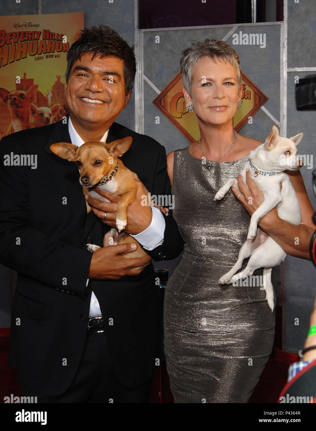 George Lopez and Jamie Lee Curtis posing the chihuahua - Beverly Hills  Chihuahua Premiere at the El Capitan Theatre in Los Angeles. posing with  the chihuahua three quarters smile eye contact -