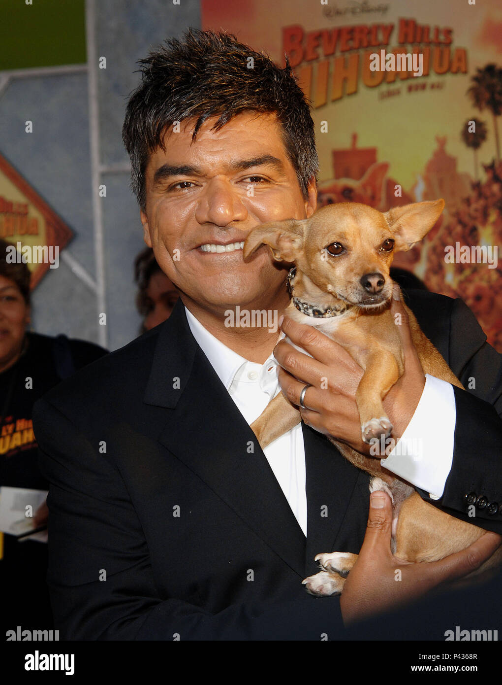 George Lopez posing the chihuahua - Beverly Hills Chihuahua Premiere at the  El Capitan Theatre in Los Angeles. posing with the chihuahua three quarters  eye contact smile - 07 LopezGeorge 07.jpg07 LopezGeorge