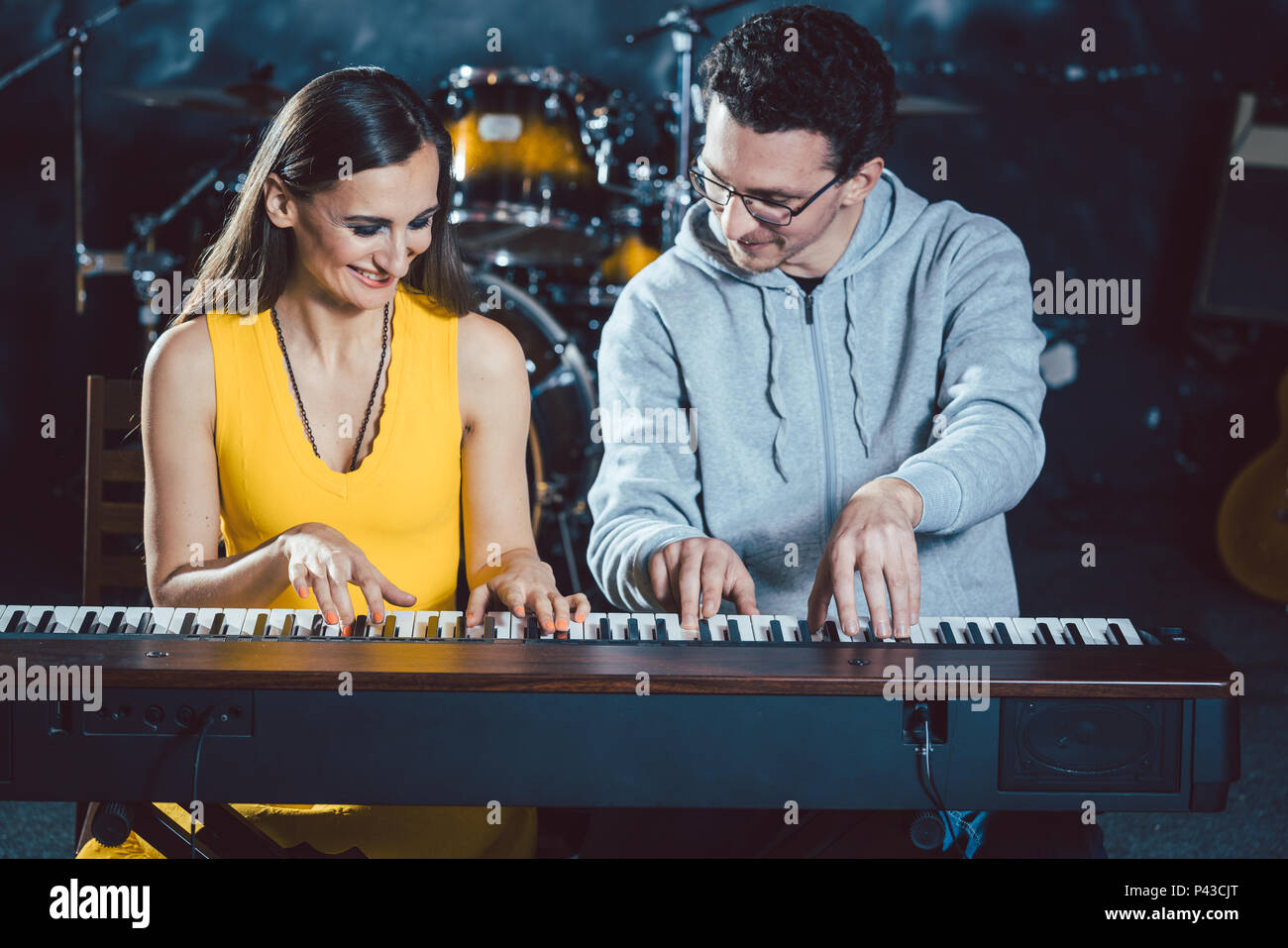 Piano teacher with his student in music school Stock Photo