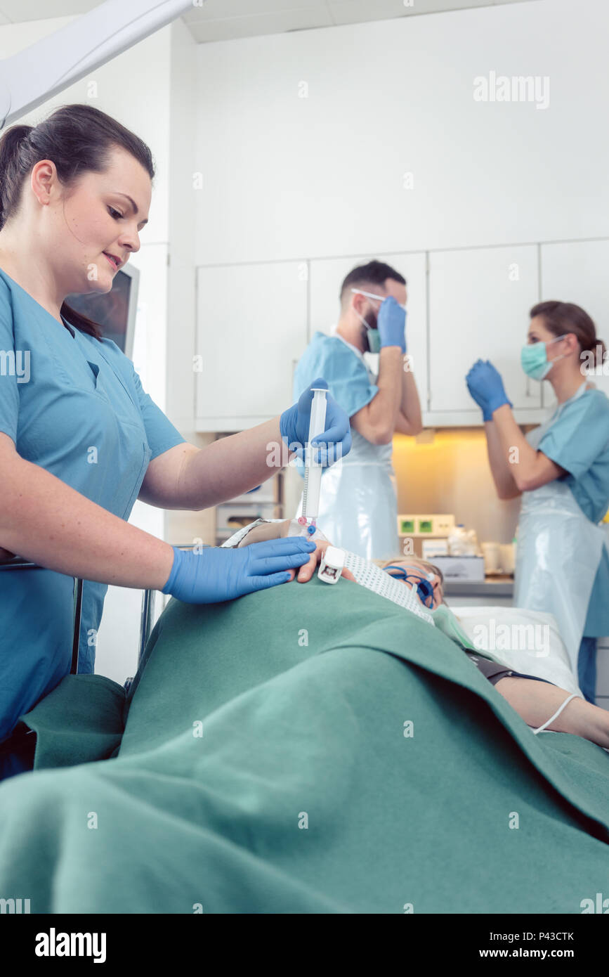 Nurse giving anesthesia to patient waiting for endoscopy Stock Photo Alamy
