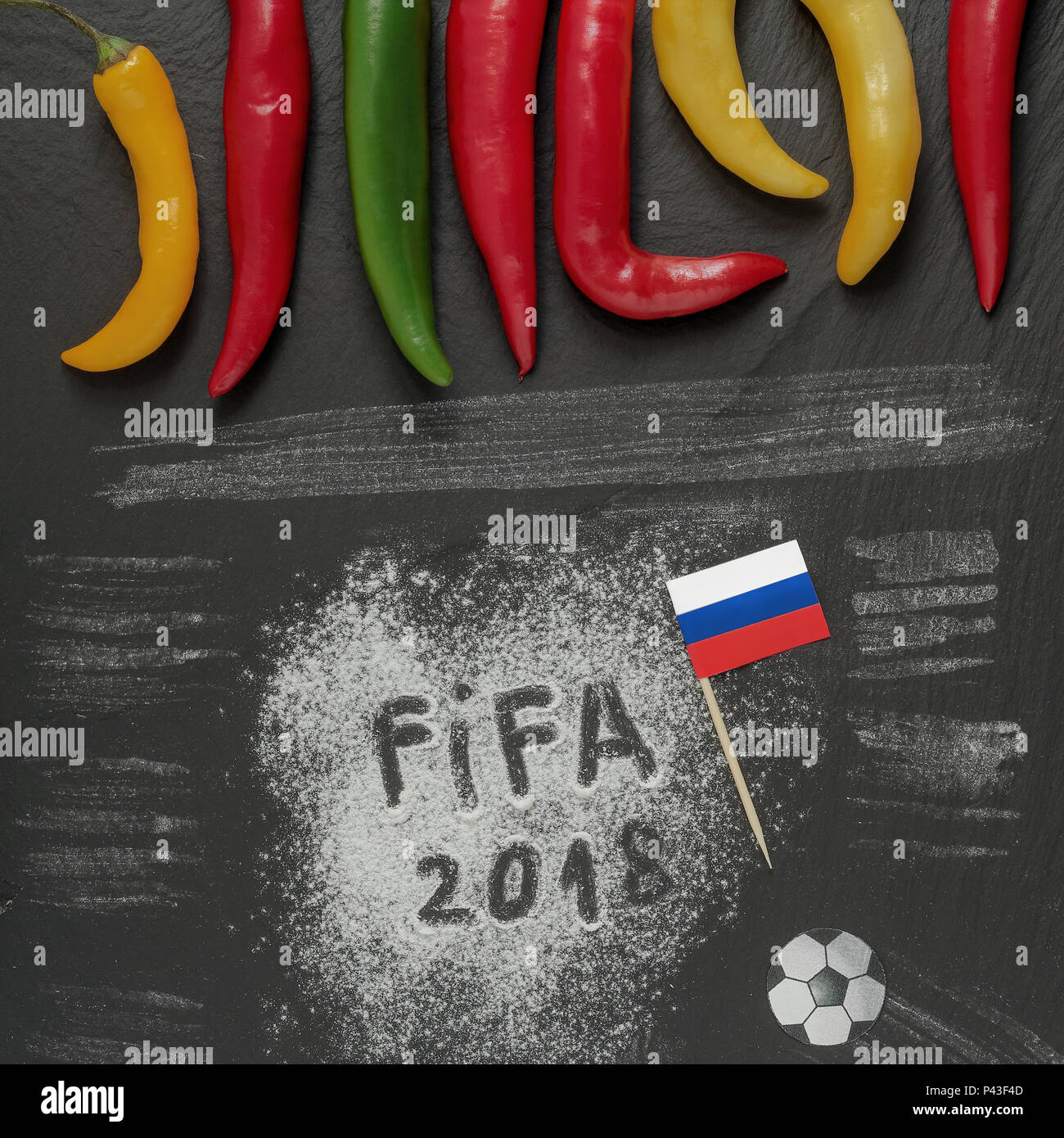 Fifa world cup 2018 Russia,flour writing with DIY paper flag,soccer ball and some hot chilli peppers. Stock Photo