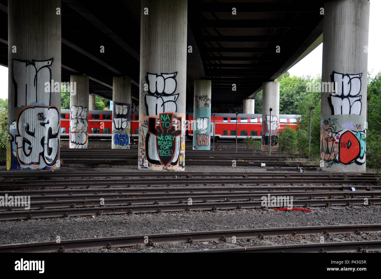 Graffiti 'Nato, we only bomb for peace!' on bridge pier on 05.07.2015 in Dortmund-Huckarde - Germany. | usage worldwide Stock Photo