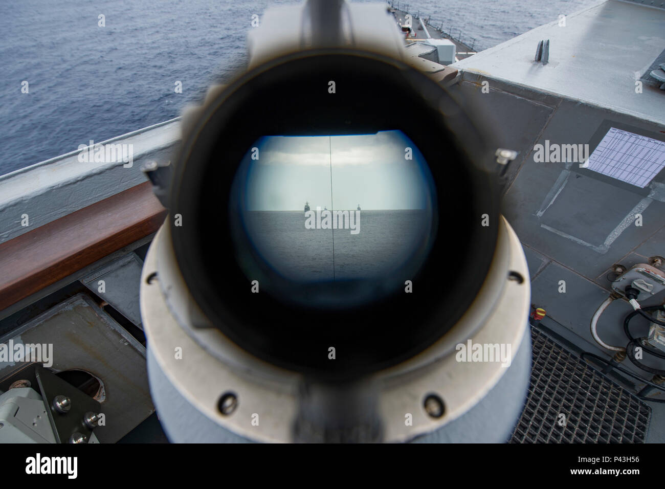 160607-N-EO381-071  ATLANTIC OCEAN (June 07, 2016) - A view of the USS Monterey (CG 61) (left), USS Mason (DDG 87) (right) and USS Roosevelt (DDG 80) through a telescopic alidade as they transit the Atlantic Ocean as part of the Eisenhower Carrier Strike Group (Ike CSG)'s deployment in support of maritime security operations and theater security cooperation efforts in the U.S. 5th and 6th Fleet areas of operation. The Ike CSG includes USS Dwight D. Eisenhower (CVN 69) (Ike), Carrier Air Wing (CVW) 3, Destroyer Squadron (DESRON) 26 and ships USS San Jacinto (CG 56), USS Monterey, USS Stout (DDG Stock Photo