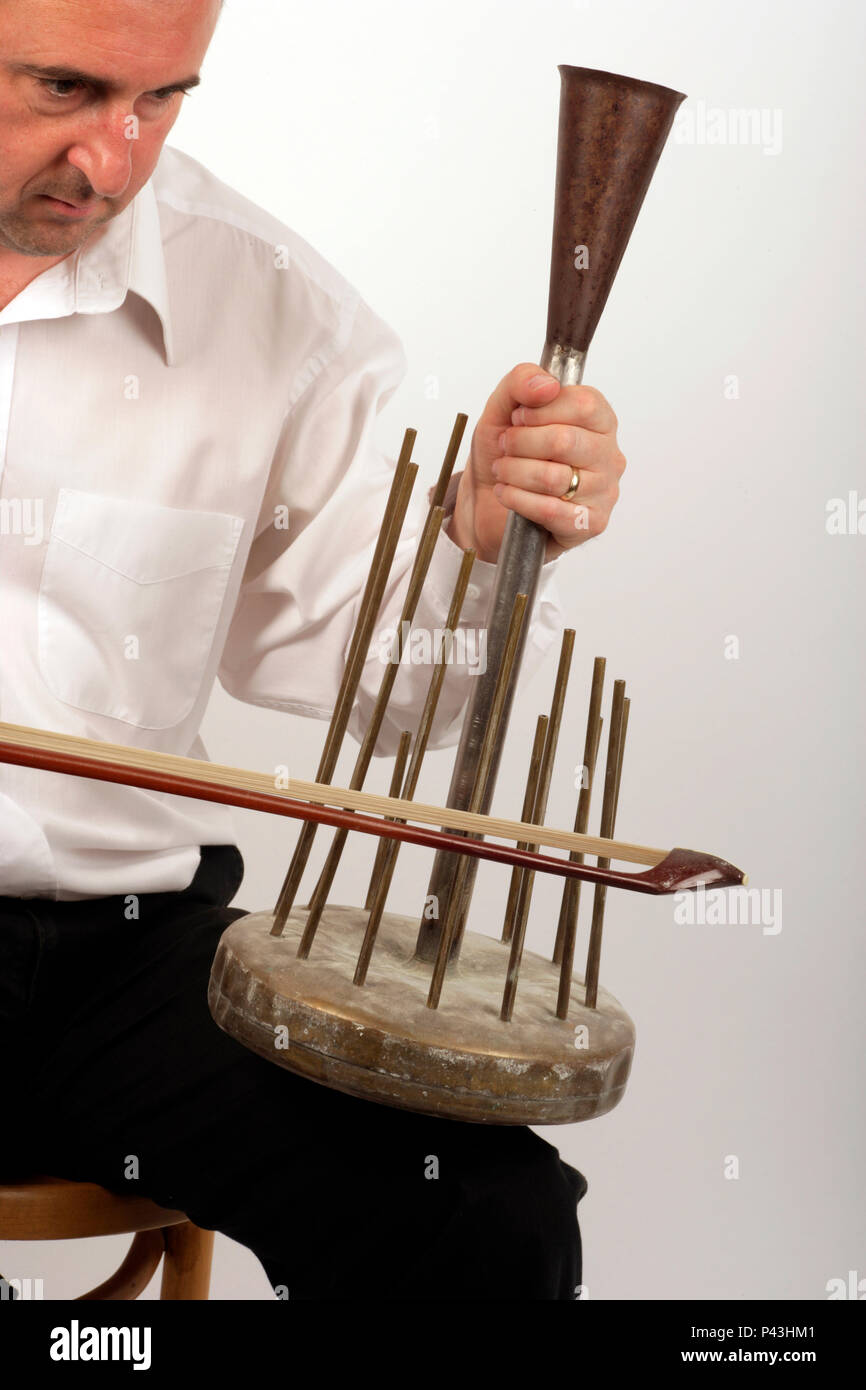 Waterphone being played by a male performer, Generic Stock Photo - Alamy