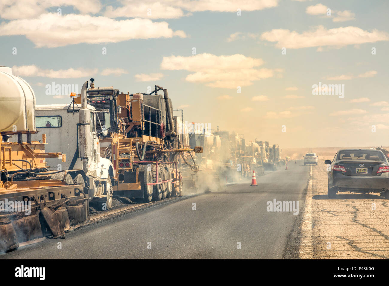 Road resurfacing with heat and air pollution obscuring vision for drivers, New Mexico, USA Stock Photo