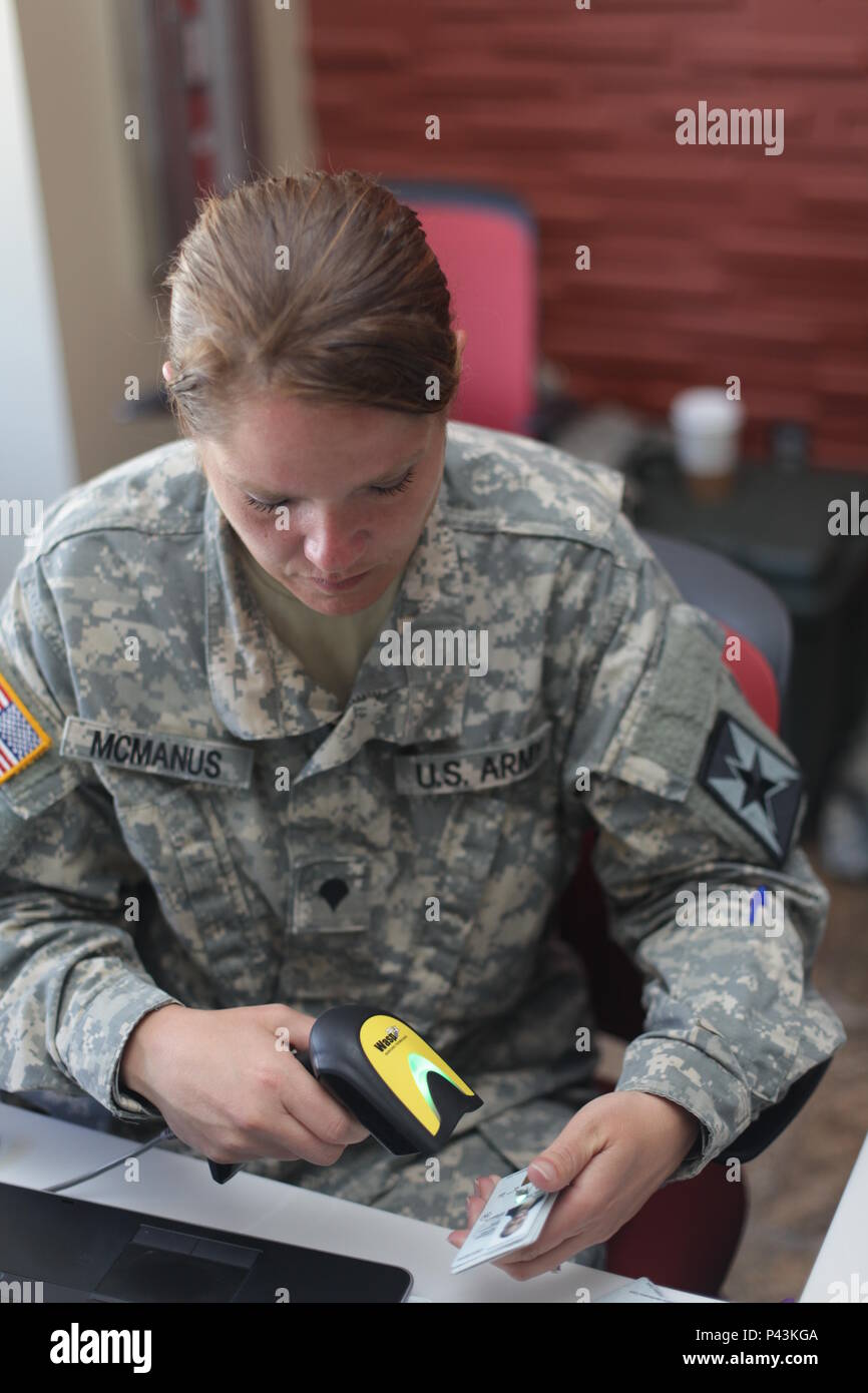 U.S. Army Spc. Kendra Mcmanus scans ID casds at the Joint Reception ...