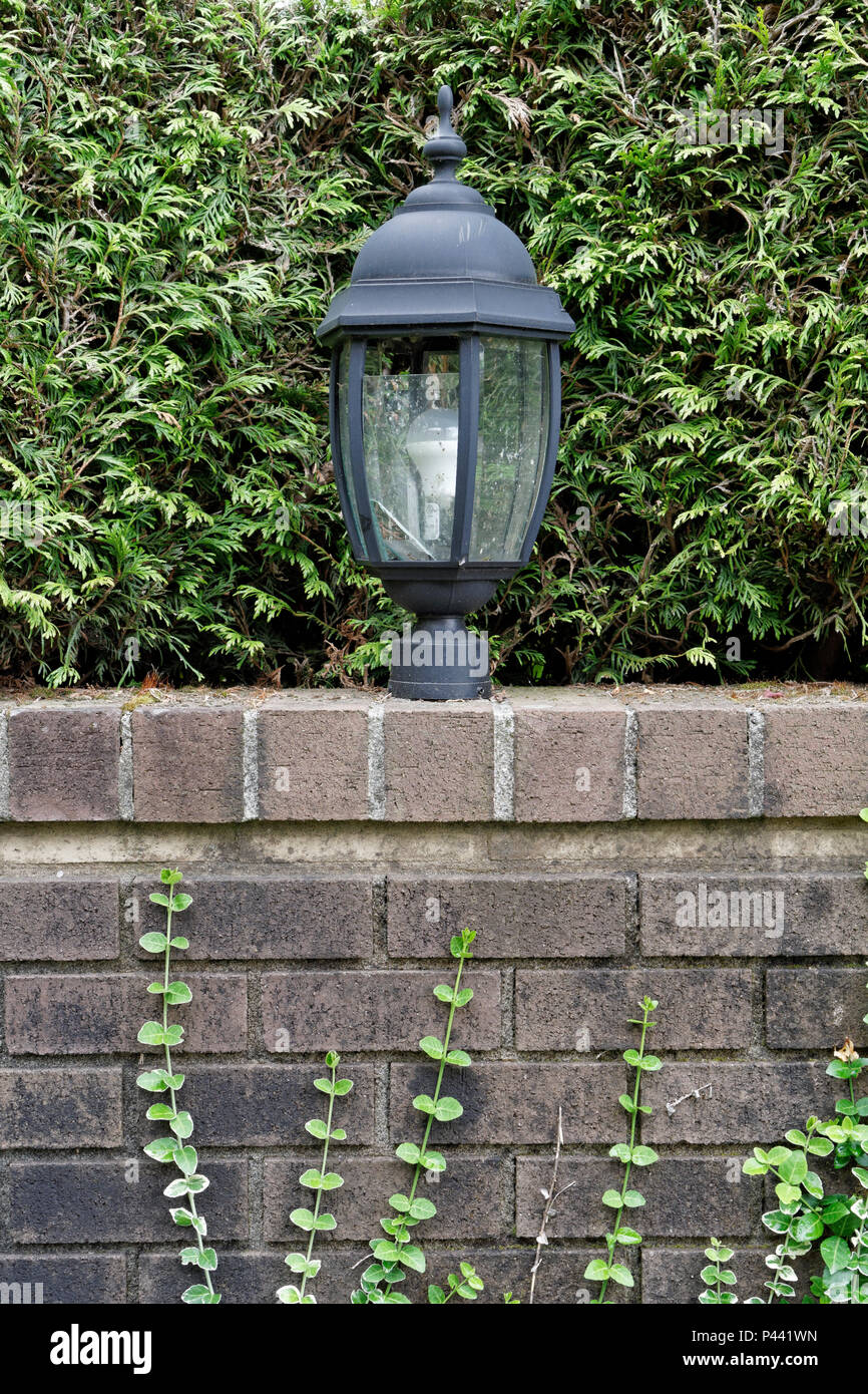 https://c8.alamy.com/comp/P441WN/outdoor-decorative-electric-metal-lantern-on-a-brick-graden-wall-P441WN.jpg