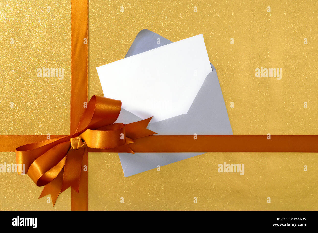 Christmas or birthday card with gift ribbon and bow in gold satin on ...