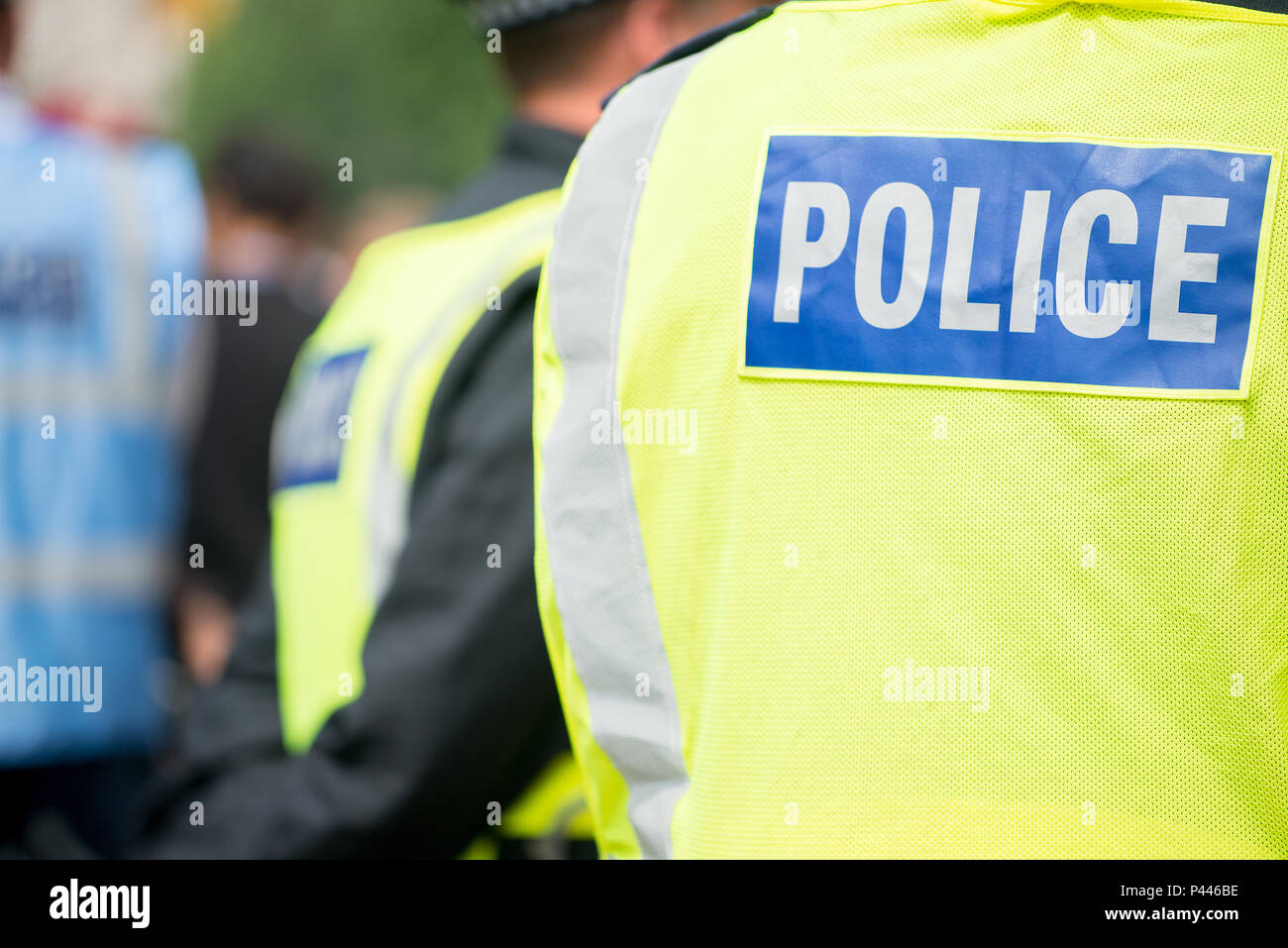 Metropolitan police officer wearing high visibility vest with POLICE printed on the back, while on duty in London, UK. Stock Photo