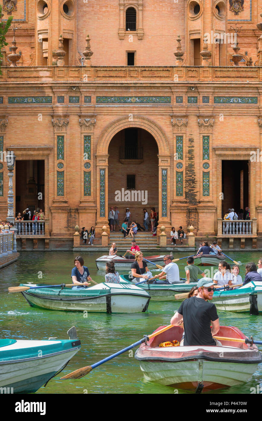 Seville Plaza de Espana, view of tourists rowing boats on the boating lake in the Plaza de Espana on a summer afternoon, Sevilla, Andalucia, Spain. Stock Photo
