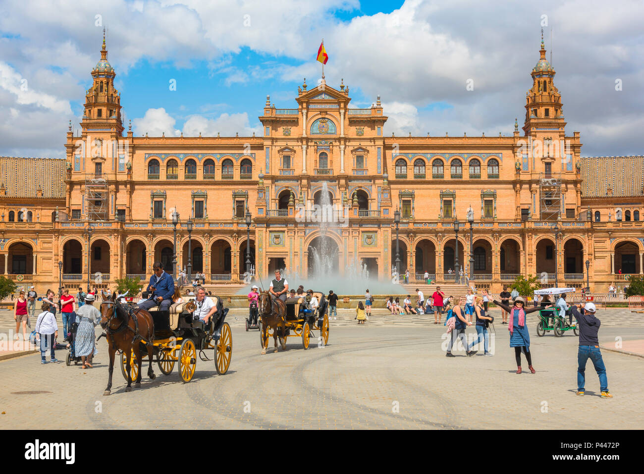 Plaza de Espana Seville, view of tourists riding in carriages through the Plaza de Espana on a summer afternoon, Sevilla, Andalucia, Spain. Stock Photo