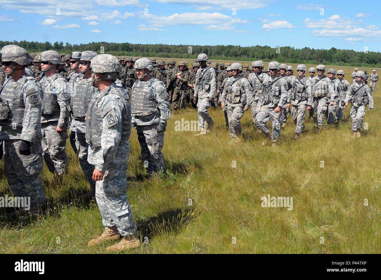 Solders of the 45th Fires Brigade, Oklahoma Army National Guard, left, and 5th Battalion, 113th Field Artillery Regiment (High Mobility Artillery Rocket System), North Carolina Army National Guard, right, march into a formation prior to the Exercise Anakonda 2016 opening ceremony at Drawsko Pomorskie Training Area, Poland, June 6, 2016. These Soldiers join thousands of Soldiers from nearly 20 countries at the exercise. AN16 is a Polish national exercise that seeks to train, exercise, and integrate Polish national command and force structures into an Allied, joint, multinational environment.  ( Stock Photo