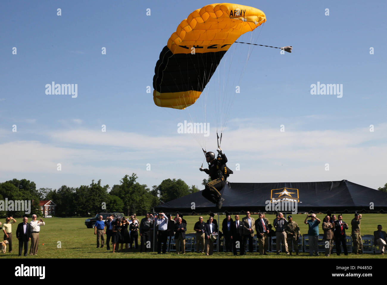 A member of the Army’s Golden Knights jumps into Brooks Field on Fort