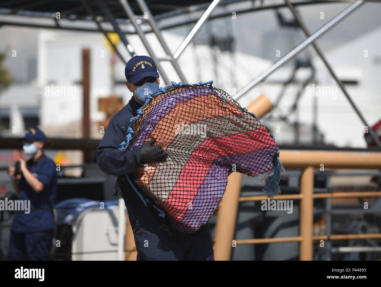 Coast Guardsmen offload approximately eight tons of seized cocaine from the Coast Guard Cutter Bernard C. Webber to Coast Guard Base Miami Beach on June 13, 2016. The drugs were interdicted in international waters of the Eastern Pacific Ocean drug transit zone off the coast of Central and South America between early April and late May. (U.S. Coast Guard photo by Eric D. Woodall) Image cropped to eliminate dead space. Stock Photo