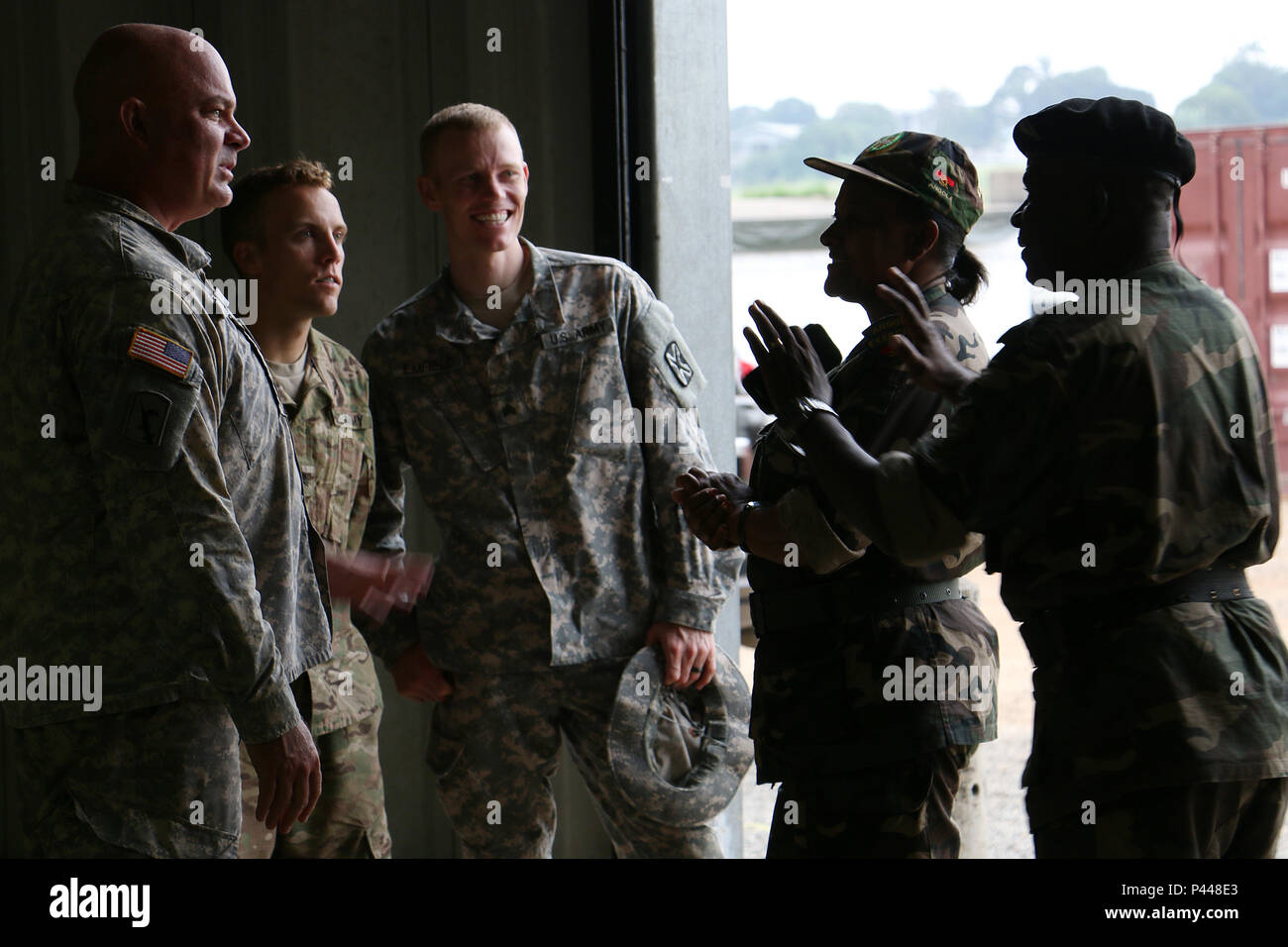 U.S. Army Portugeuse translators of 141st Military Intelligence Battalion, 300th MI Brigade, Utah Army National Guard, discuss the Opening Day Ceremony for Central Accord 2016 with representatives of the Angola military June 12, 2016 at the Cooperative Security Location in Libreville, Gabon. U.S. Army Africa's exercise Central Accord 2016 is an annual, combined, joint military exercise that brings together partner nations to practice and demonstrate proficiency in conducting peacekeeping operations. (U.S. Army photo by Staff Sgt. Candace Mundt/Released) Stock Photo