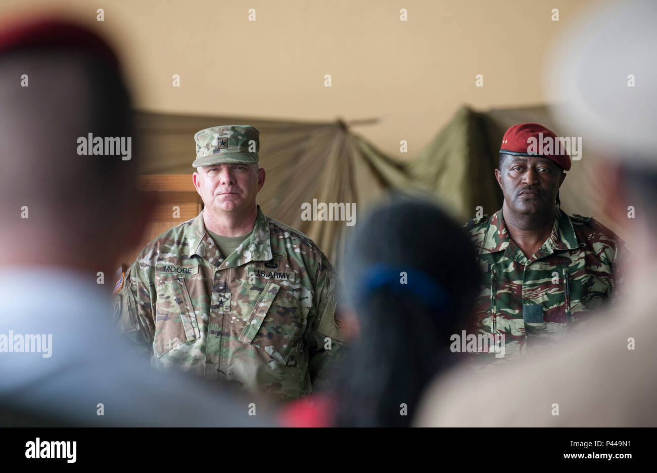 U.S. Army Brig. Gen. Kenneth Moore Jr. (left), Deputy Commander U.S. Army Africa Command, and Brig. Gen. Ferdinand Gaspard Olame Ndong, Deputy Chief of the General Staff of the Gabonese Armed Forces, stand before representatives from approximately 14 partner nations during the opening day ceremony for this year’s Central Accord Exercise in Libreville, Gabon on June 13, 2016. U.S. Army Africa’s exercise Central Accord 2016 is an annual, combined, joint military exercise that brings together partner nations to practice and demonstrate proficiency in conducting peacekeeping operations. (DoD News  Stock Photo