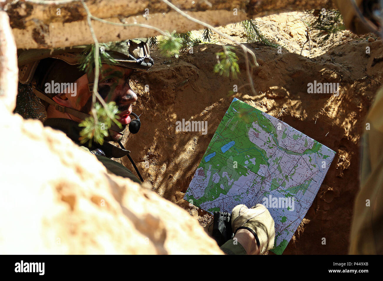 A Norwegian Soldier Inside A Defensive Position Points To A Location On A Map During A Simulated Battle Demonstration For Distinguished Visitors By Soldiers From The United Kingdom Norway And Poland During
