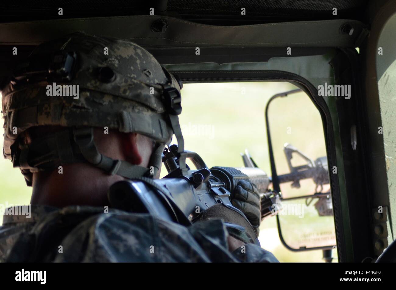 U.S. Army Sgt. Joseph Rogers of the 396th Medical Company (Ground Ambulance), Army Reserve, engages opposing forces during a simulated convoy ambush in support of the Golden Coyote exercise, Camp Guernsey, Wyo., June 15th, 2016. The Golden Coyote exercise is a three-phase, scenario-driven exercise conducted in the Black Hills of South Dakota and Wyoming, which enables commanders to focus on mission essential task requirements, warrior tasks and battle drills. (U.S. Army photo by Pfc. Michael Britt/Released) Stock Photo