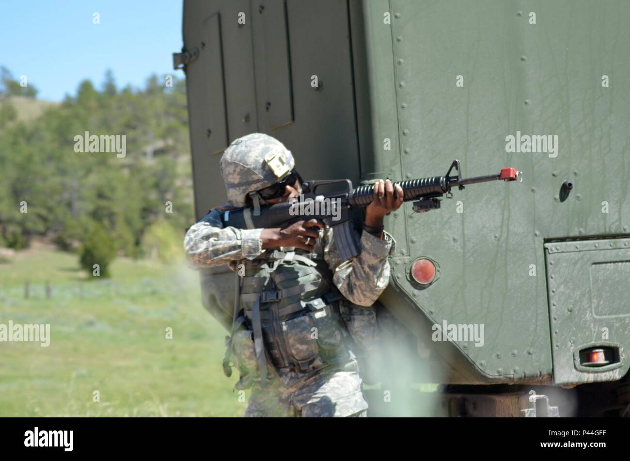 U.S. Army Cpt. Crystal Giocondo of the 396th Medical Company (Ground Ambulance), Army Reserve, engages enemy opposing forces during a simulated convoy ambush in support of the Golden Coyote exercise in Camp Guernsey, Wyo., June 15th, 2016. The Golden Coyote exercise is a three-phase, scenario-driven exercise conducted in the Black Hills of South Dakota and Wyoming, which enables commanders to focus on mission essential task requirements, warrior tasks and battle drills. (U.S. Army photo by Pfc. Michael Britt/ Released) Stock Photo