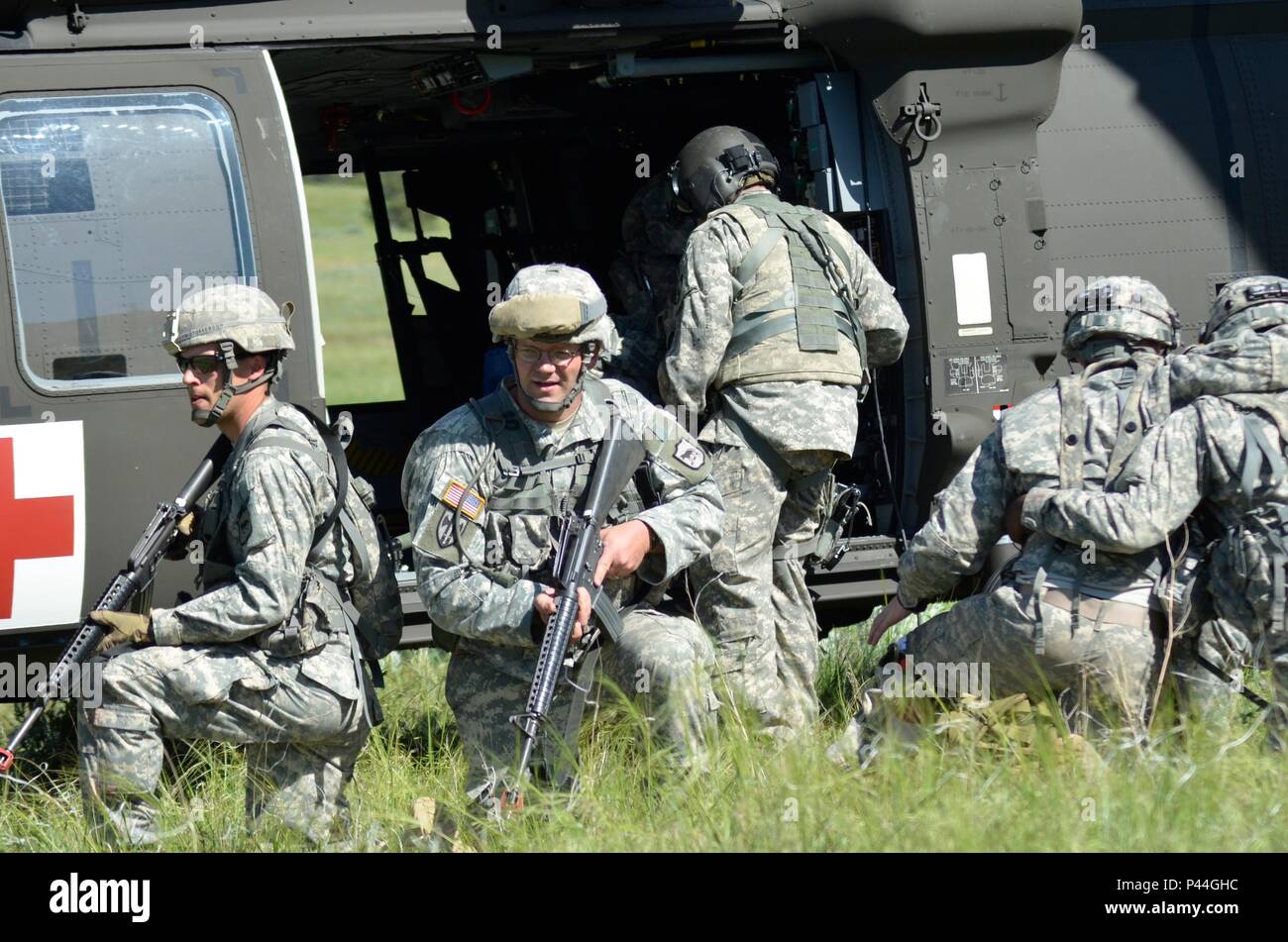 U.S. Army Soldiers of the 396th Medical Company (Ground Ambulance), Army Reserve and 235th Military Police Company, South Dakota Army National Guard, load casualties on a UH-60 Blackhawk during a simulated in support of the Golden Coyote exercise in Camp Guernsey, Wyo., June 15th, 2016. The Golden Coyote exercise is a three-phase, scenario-driven exercise conducted in the Black Hills of South Dakota and Wyoming, which enables commanders to focus on mission essential task requirements, warrior tasks and battle drills. (U.S. Army photo by Pfc. Michael Britt/ Released) Stock Photo