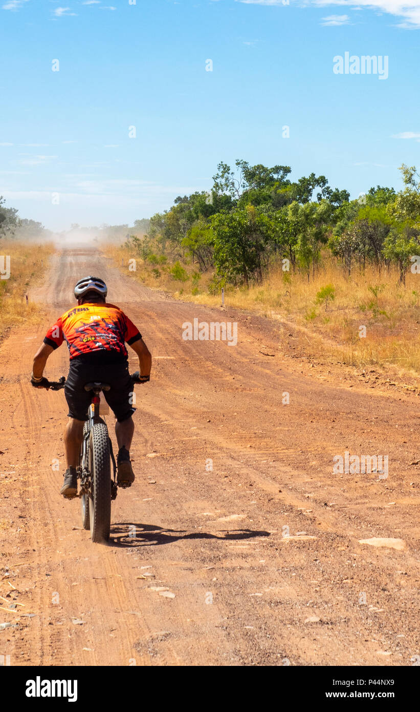 Gibb Challenge 2018 a cyclist in Jersey and bib riding a fatbike on dirt road Gibb River Road Kimberley Australia Stock Photo