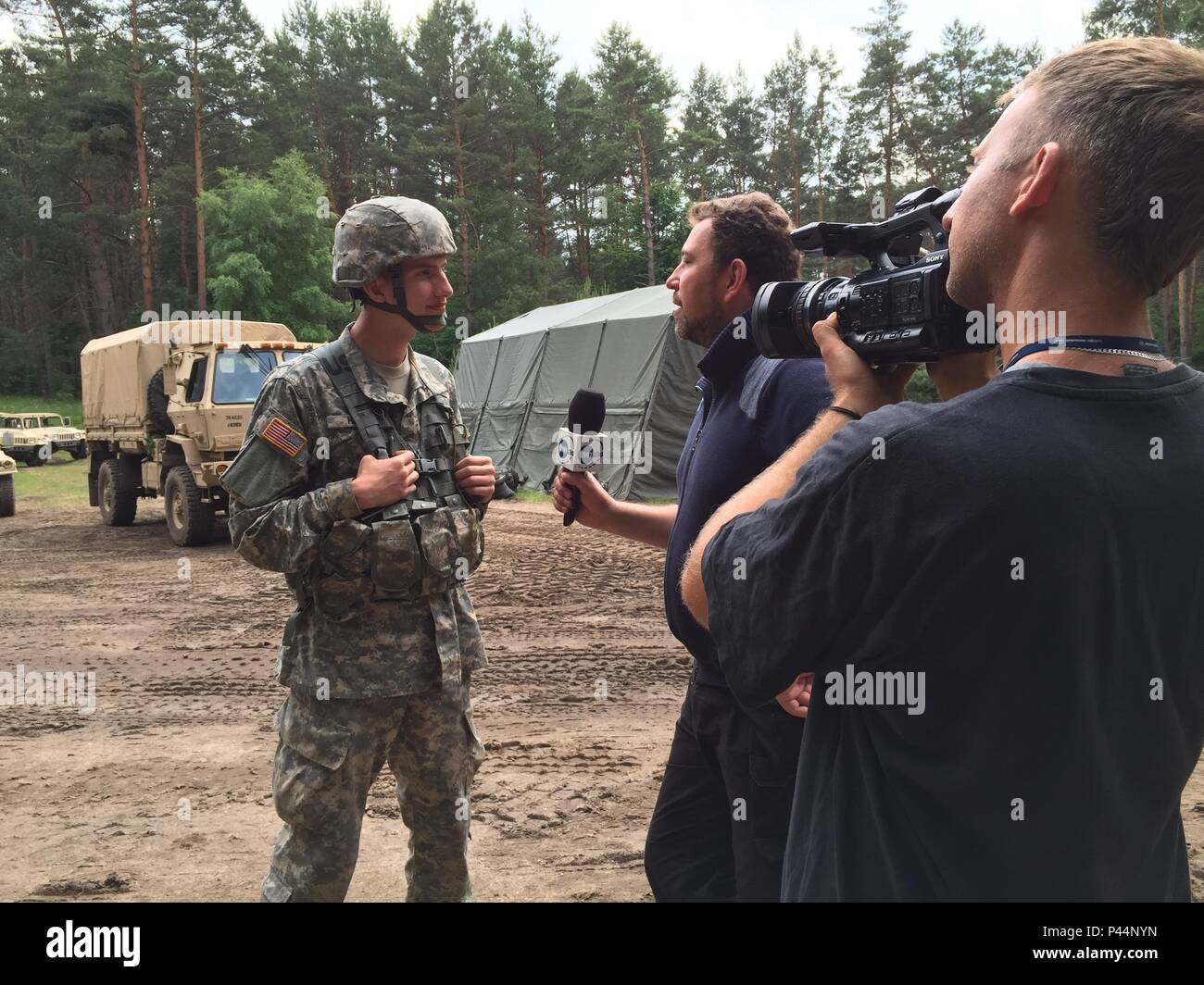U.S. Army Reserve Pfc. James Hale, a Transportation Management Coordinator with the 382nd Combat Sustainment Support Battalion, Joint Base Lewis-McChord, Washington, is interviewed by a Polish television reporter during Exercise Anakonda 2016 at the Drawsko Pomorskie Training Area, Poland, June 14. Hale, the son of American missionaries, was born in Poland and has lived most of his life there. He has served as a Polish translator for the soldiers in his unit during their time in Poland. Exercise Anakonda 2016 is a Polish-led, joint multinational exercise taking place throughout Poland June 7-1 Stock Photo