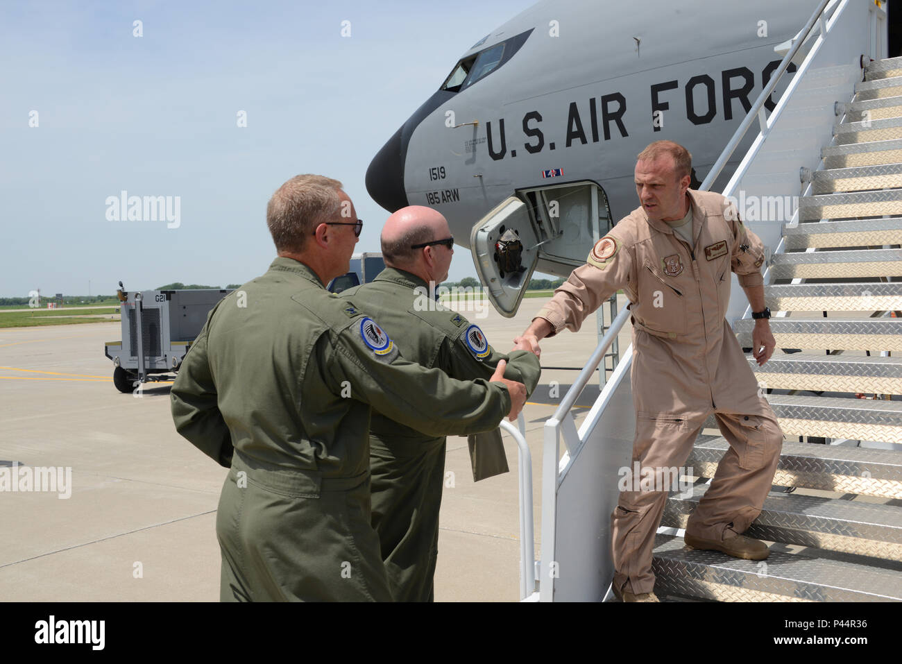 Col Lawrence Christensen, 185th Air Refueling Wing Commander, Iowa Air National Guard and Colonel Jim Walker 185th Operations Group commander, greet Senior Master Sgt. Chuck Heald at the bottom of the air stair of a KC-135R Stratotanker, in Sioux City, Iowa on June 11, 2016 after returning from Al Udeid Air Base. 185th ARW unit members and aircraft were temporarily assigned to the 340th Expeditionary Air Refueling Squadron at Al Udeid since February, where they were providing midair refueling support for U.S. and partner nation aircraft in direct support of Operation Inherent Resolve.  (U.S. A Stock Photo