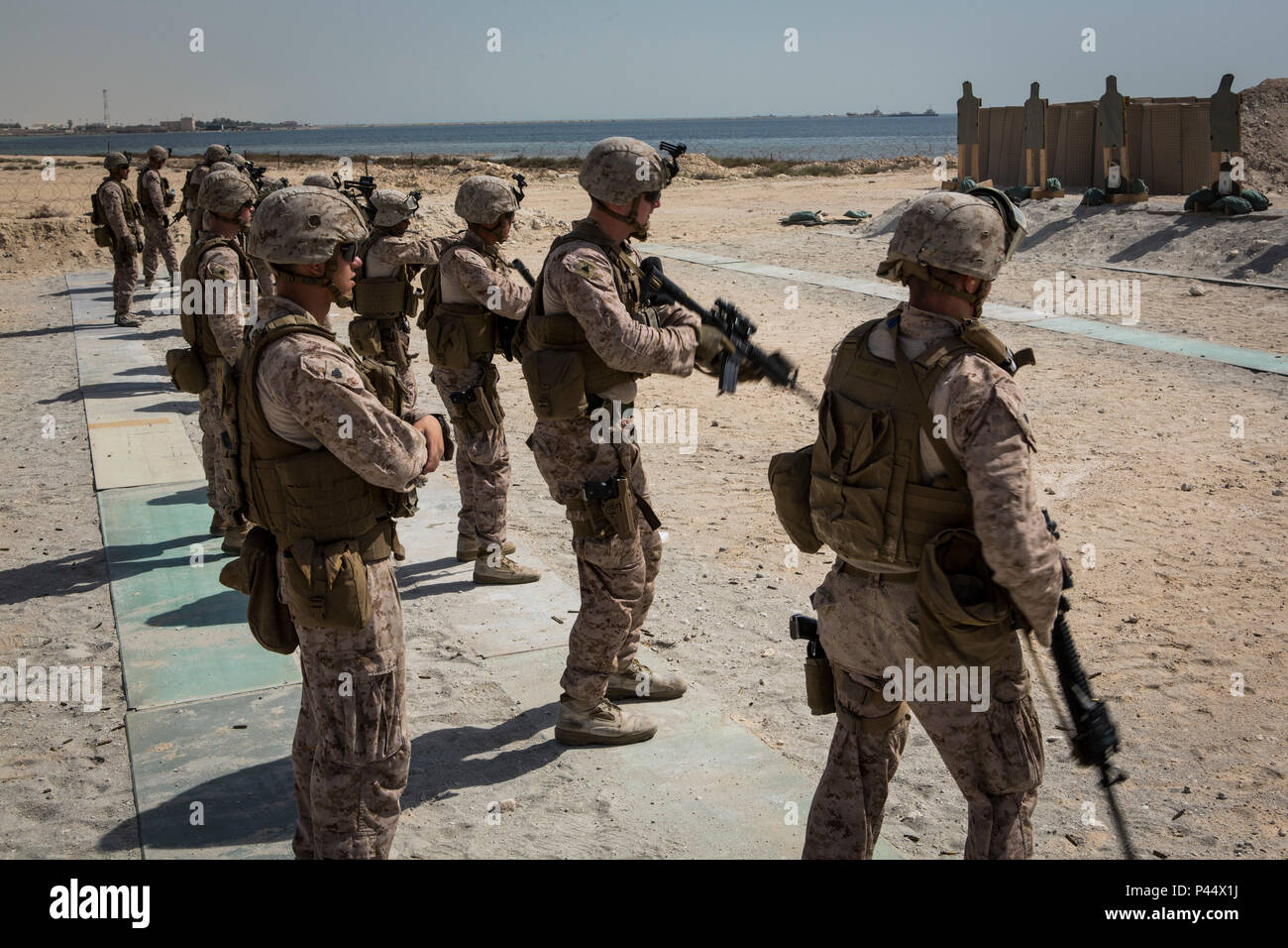 U.S. Marines with Company C, Marine Wing Support Squadron 373, Special Purpose Marine Air Ground Task Force - Crisis Response - Central Command, conduct rifle to pistol transitions during a combat marksmanship practice range at an undisclosed location in Southwest Asia, June 5, 2016. SPMAGTF-CR-CC is forward deployed in several host nations, with the ability to respond to a variety of contingencies rapidly and effectively. (U.S. Marine Corps photo by Sgt. Donald Holbert/ Released) Stock Photo