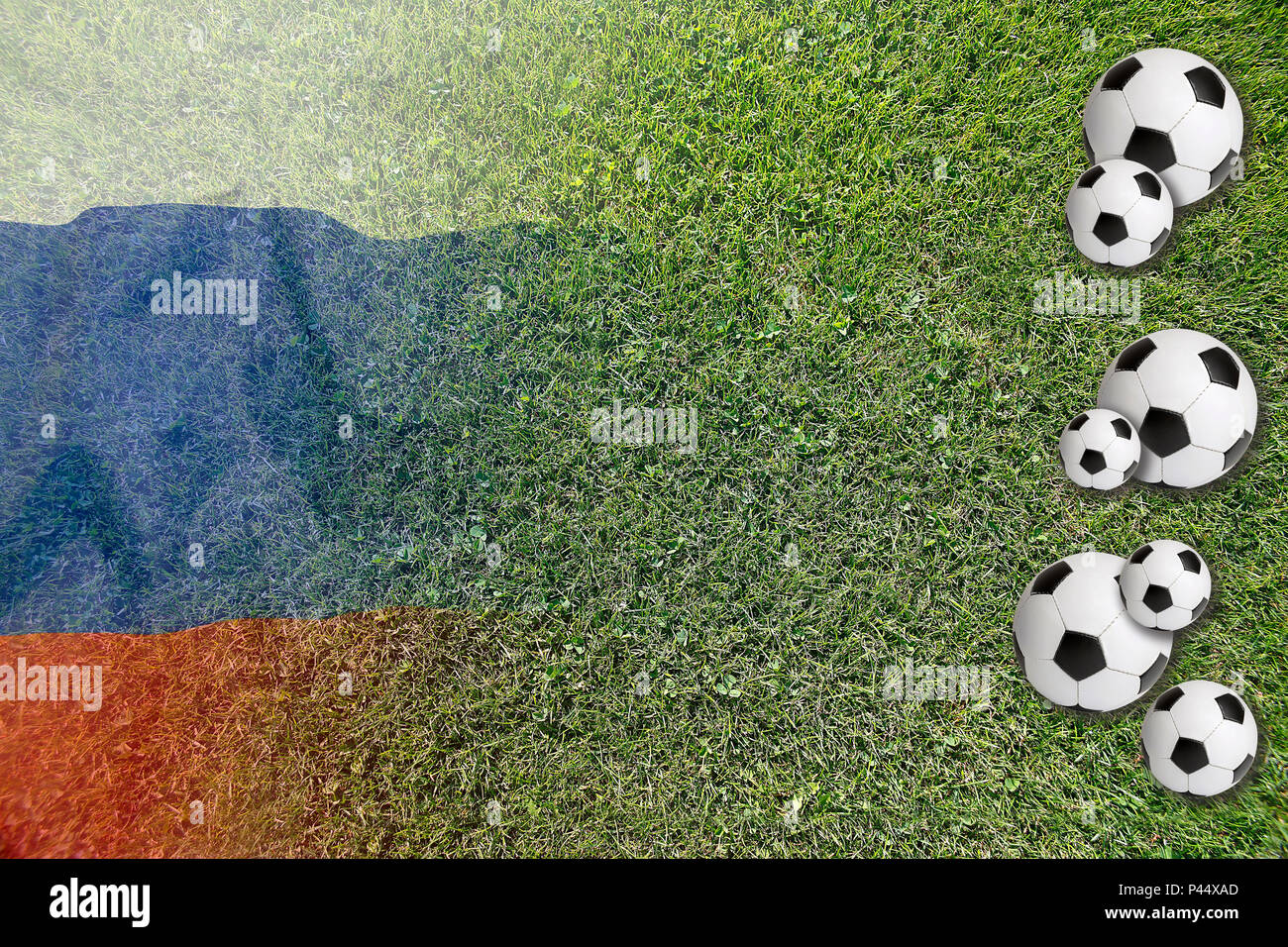 Soccer balls on green lawn with Russian national flag Stock Photo